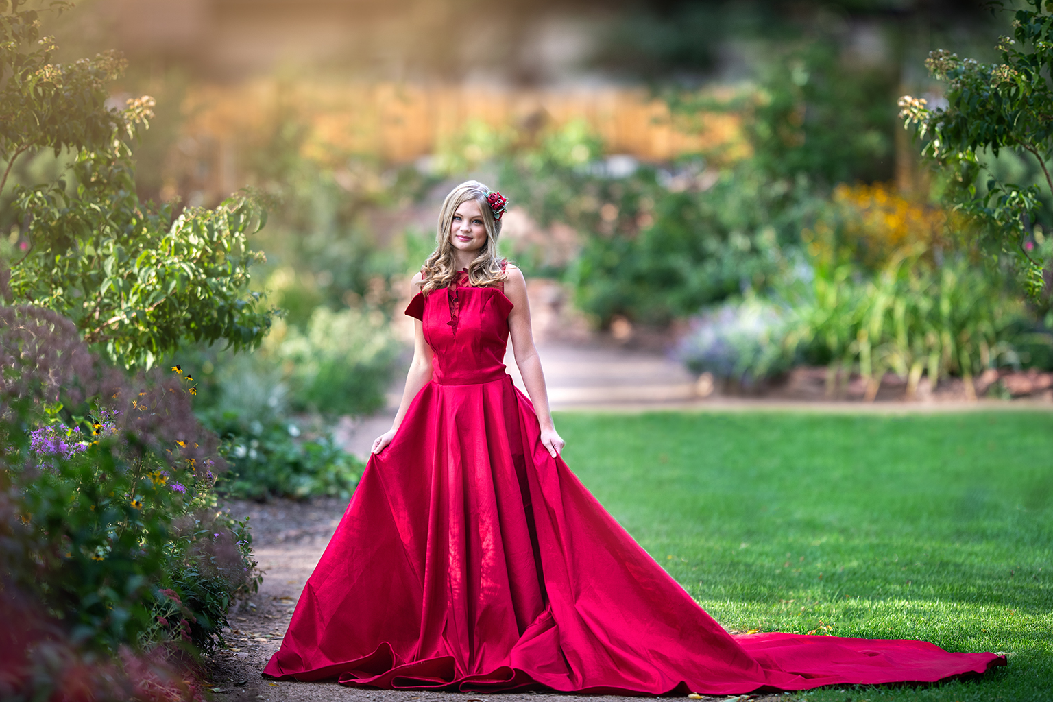 A young girl wearing a red gown.