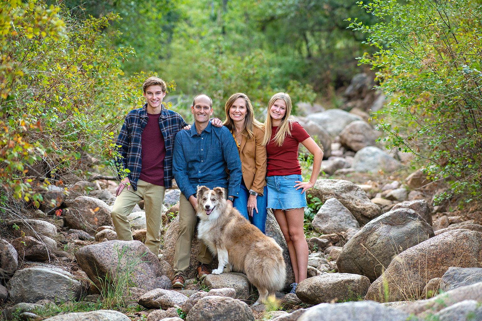 A family of four with their dog in a canyon.