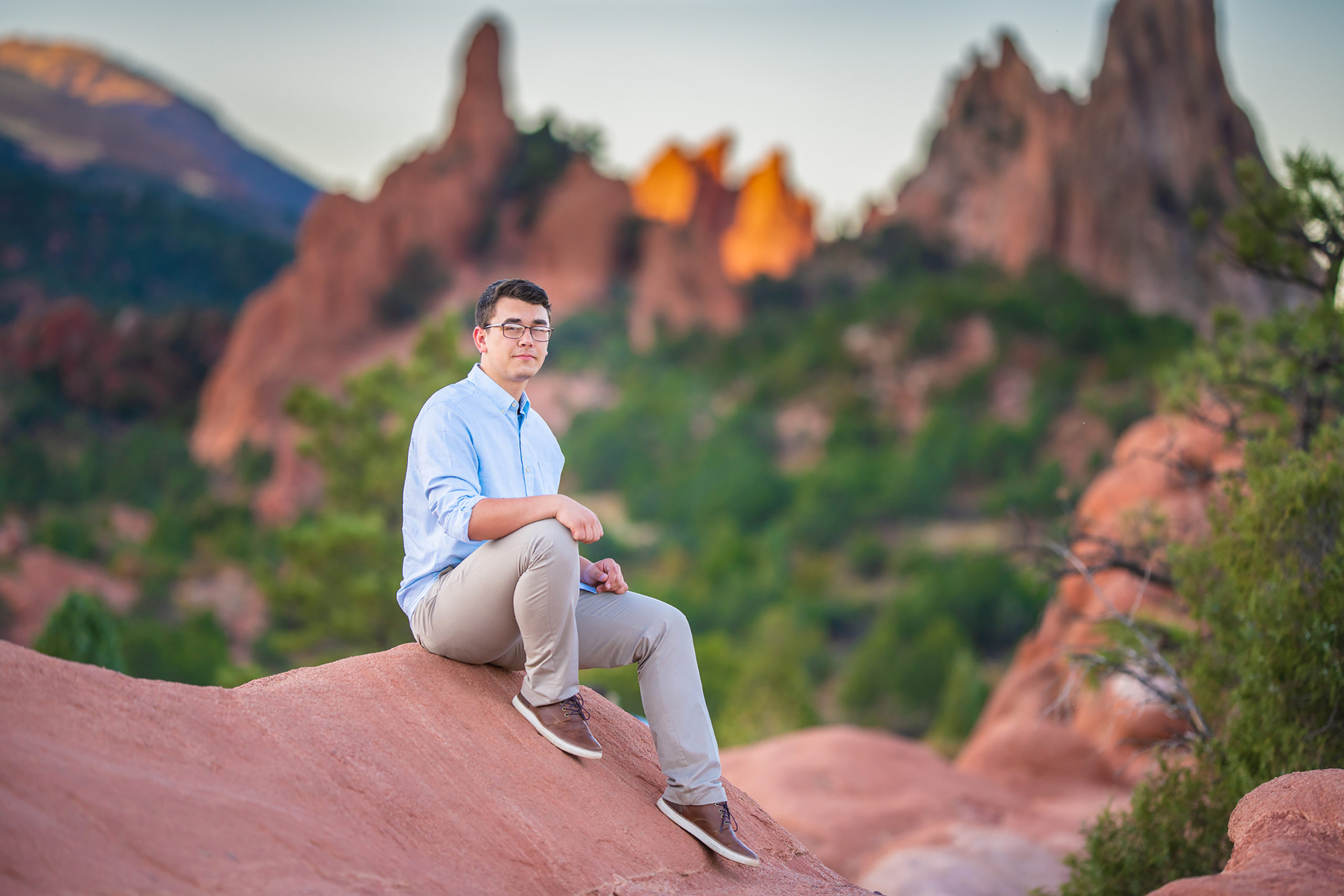 A young man sitting on a rock in the Garden of the Gods.